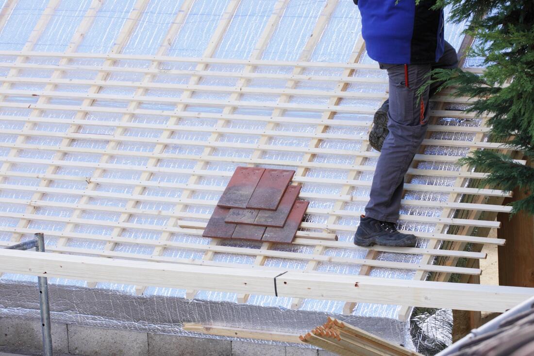 worker installing roof tile