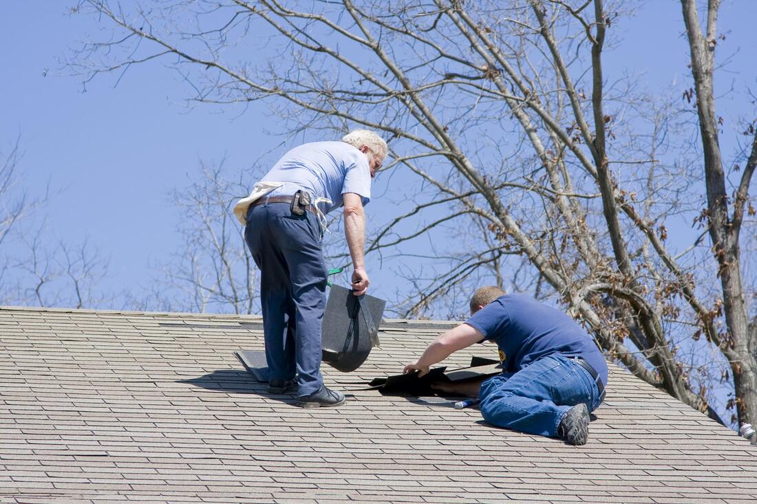 two workers fixing the roof