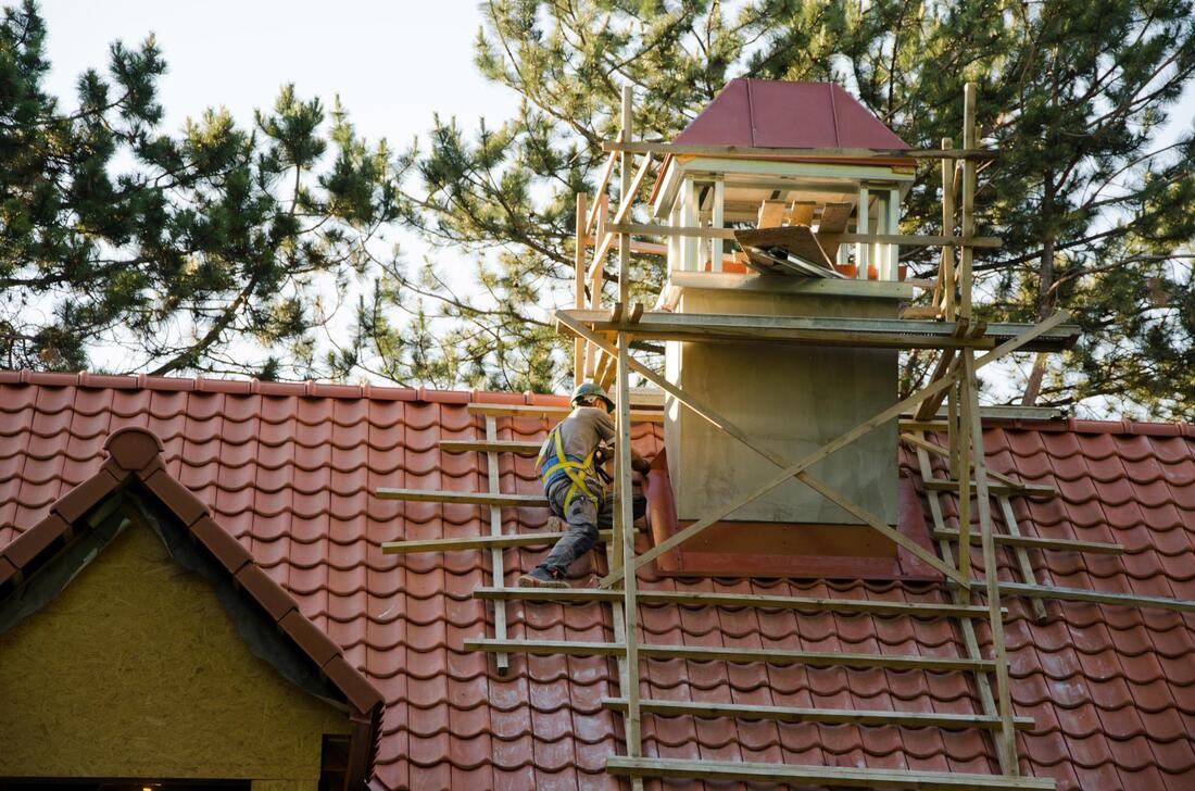 worker fixing the chimney
